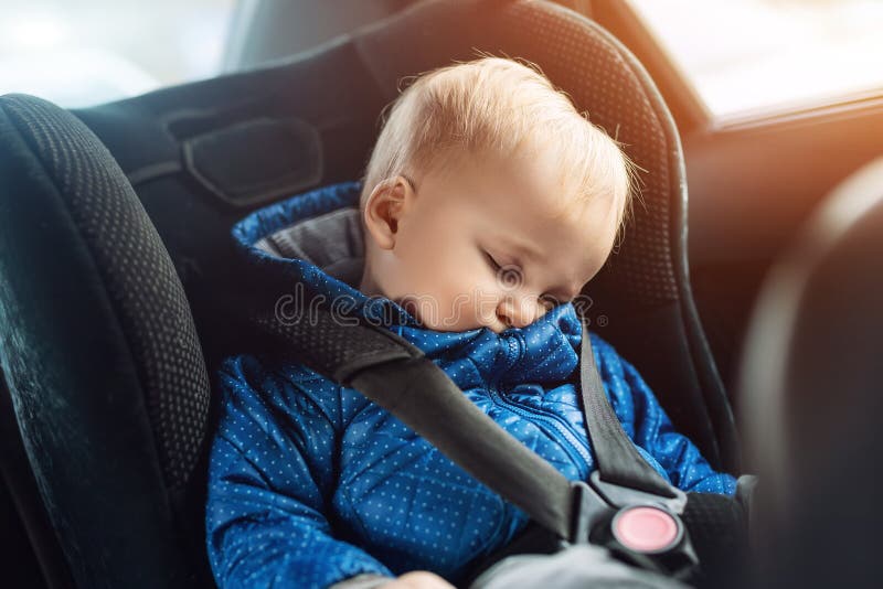 Cute caucasian toddler boy sleeping in child safety seat in car during road trip. Adorable baby dreaming asleep in comfortable chair during journey in vehicle. Children care and safety on roads kid transportation travel protection belt automobile security childhood infant strap passenger seatbelt portrait small little sitting family lifestyle prevention blue secure childcare window male blond funny. Cute caucasian toddler boy sleeping in child safety seat in car during road trip. Adorable baby dreaming asleep in comfortable chair during journey in vehicle. Children care and safety on roads kid transportation travel protection belt automobile security childhood infant strap passenger seatbelt portrait small little sitting family lifestyle prevention blue secure childcare window male blond funny