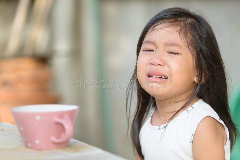 Cute little asian girl crying because don't eat breakfast on morning. Cute little asian girl crying because don't eat breakfast on morning.