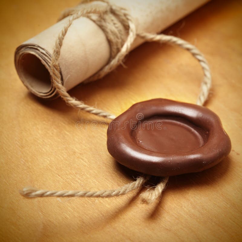 Scroll with wax seal on a wooden table. Scroll with wax seal on a wooden table