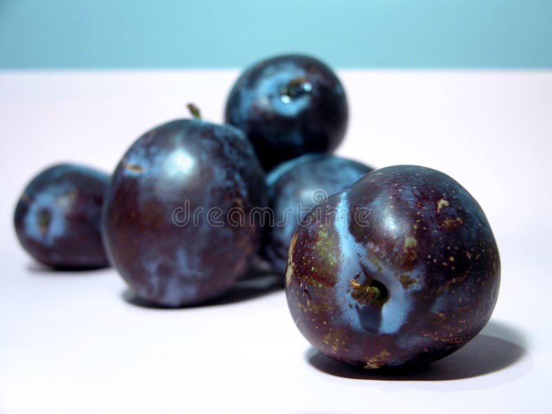 Plums on white background (custom white balance). First one to the right is in focus, the ones in the background are blurred. Plums on white background (custom white balance). First one to the right is in focus, the ones in the background are blurred.