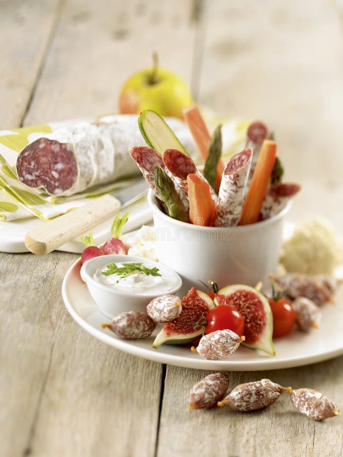 Dried sausage and raw vegetables with creamy dip,food, gastronomy, cooking,cookery. Dried sausage and raw vegetables with creamy dip,food, gastronomy, cooking,cookery