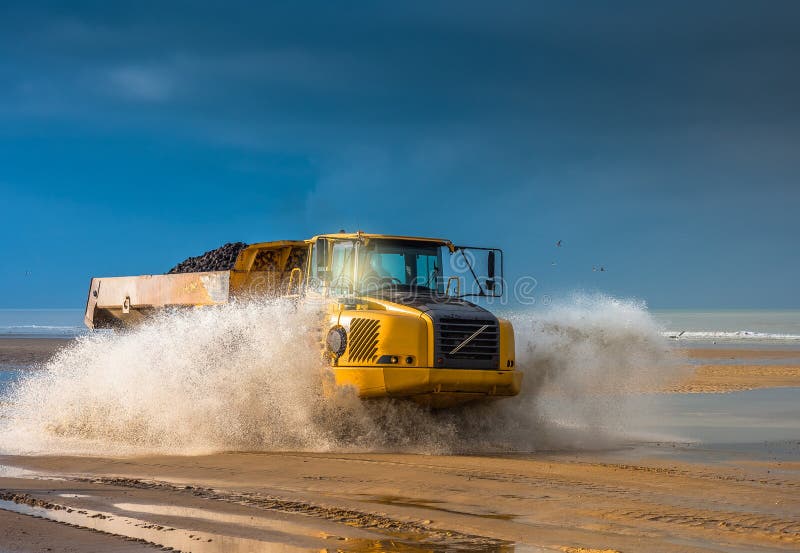 dumper at work on a construction site near a beach. dumper at work on a construction site near a beach