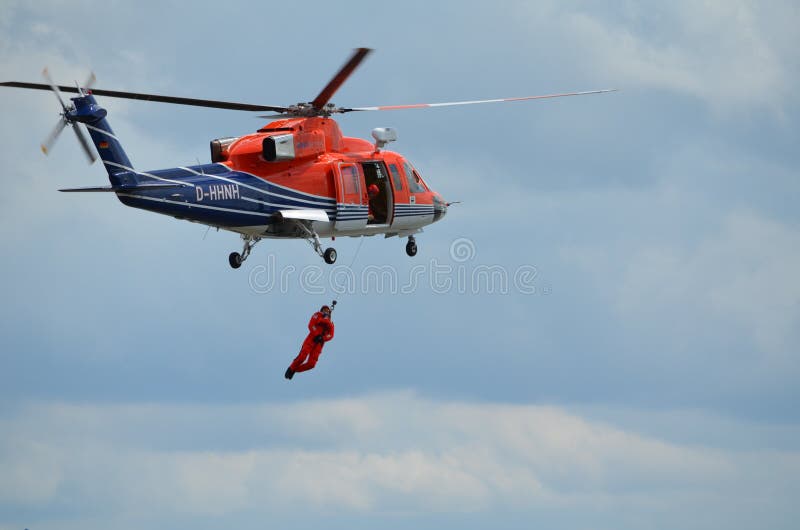 A worker is rescued from a life raft by a helicopter with a winch. Public demonstration of an offshore rescue training during Research and Science Exhibition Days at the fishery harbor of the City of Bremerhaven / Germany, on 01. July, 2012. A worker is rescued from a life raft by a helicopter with a winch. Public demonstration of an offshore rescue training during Research and Science Exhibition Days at the fishery harbor of the City of Bremerhaven / Germany, on 01. July, 2012.