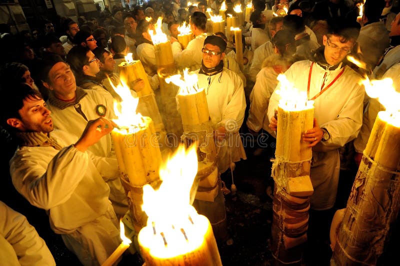 Churchgoers are lighting big candles during the crowded festivity of Patron Saint Agata. On 5 of February thousands of white dressed catholic believers overcrowd the streets in Catania screaming, running and praying. Churchgoers are lighting big candles during the crowded festivity of Patron Saint Agata. On 5 of February thousands of white dressed catholic believers overcrowd the streets in Catania screaming, running and praying.