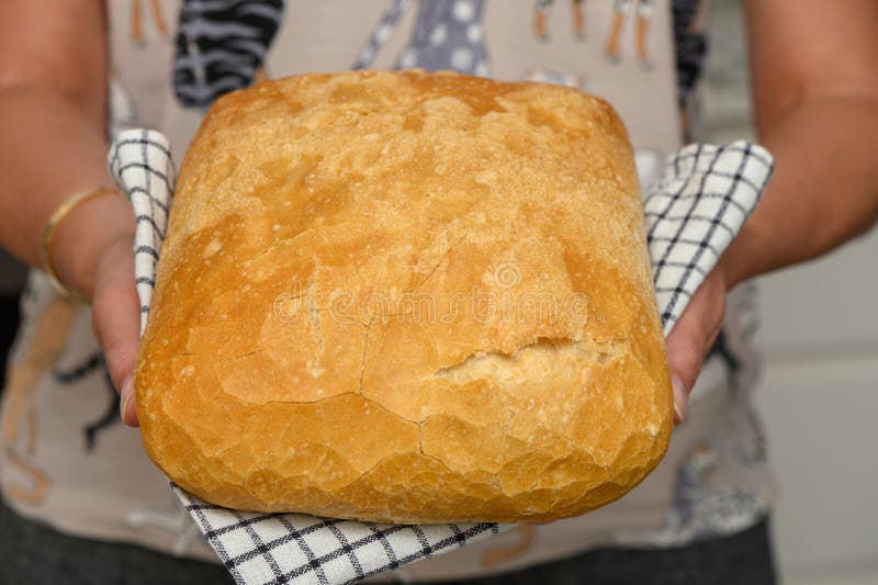 fresh homemade bread in the hands of a woman in the kitchen 3. fresh homemade bread in the hands of a woman in the kitchen 3