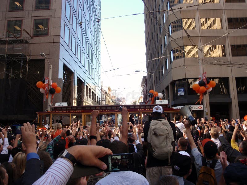 SAN FRANCISCO, CA - NOVEMBER 3: Giants fans celebrate and take photos of the passing of trolleys featuring giants players Pat Burrell and Aubrey Huff during world championship parade with fans waving and taking photos Nov. 3, 2010 San Francisco, CA. SAN FRANCISCO, CA - NOVEMBER 3: Giants fans celebrate and take photos of the passing of trolleys featuring giants players Pat Burrell and Aubrey Huff during world championship parade with fans waving and taking photos Nov. 3, 2010 San Francisco, CA.