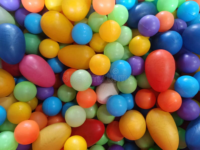 Żywe kolorowe zestawy plastikowych kulek różnej wielkości i kształtów tworzące zabawne i ekscytujące tło pełnoklatkowe fotografia stock