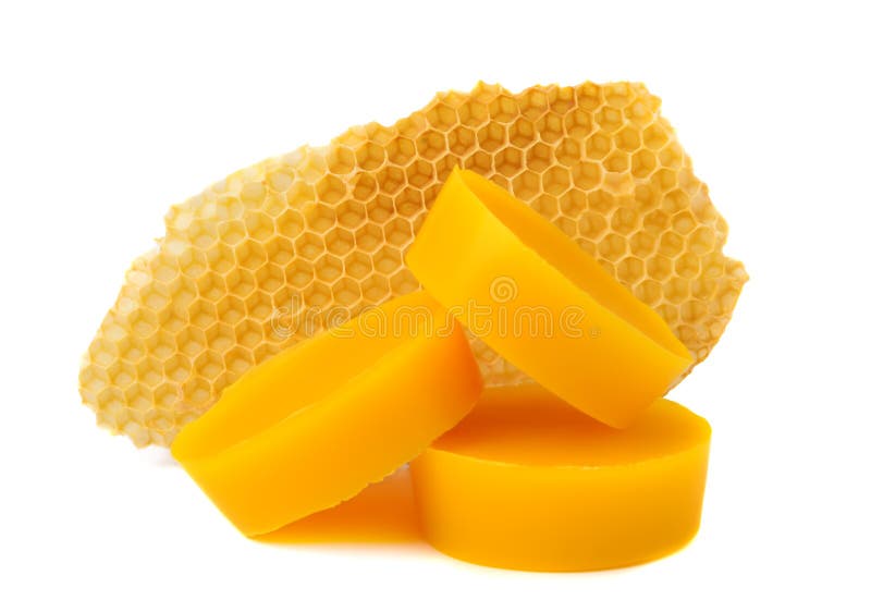 Yellow natural bee wax with a piece of honey cell on a white background. Yellow natural bee wax with a piece of honey cell on a white background