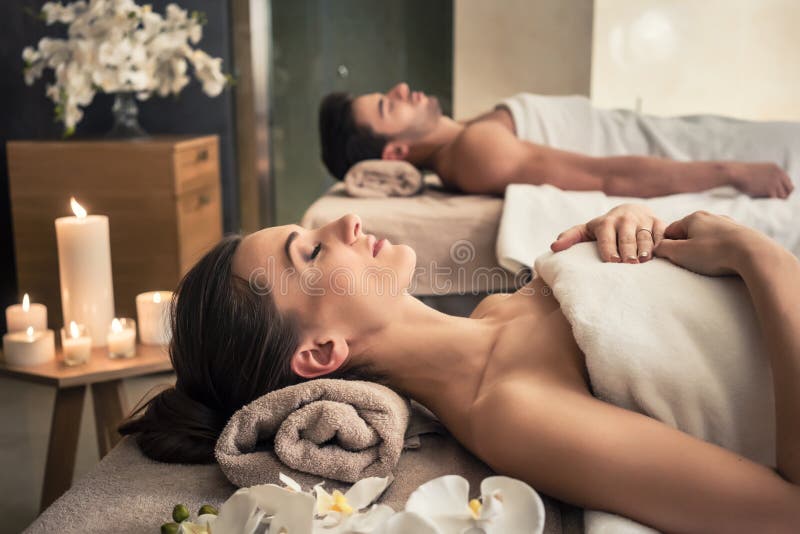 Young men and women lying down on massage beds at Asian luxury spa and wellness center. Young men and women lying down on massage beds at Asian luxury spa and wellness center