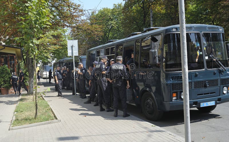 Men militia, policemen, standing waiting on the street near service buses guarding public event. May 25, 2012. Kyiv, Ukraine. Men militia, policemen, standing waiting on the street near service buses guarding public event. May 25, 2012. Kyiv, Ukraine