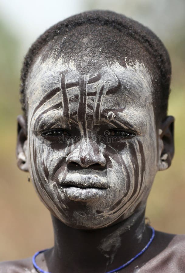 People of Africa, The Mursi (or Murzu) boy with traditional paintings over his face. Debub Omo Zone. Ethiopia. Africa. People of Africa, The Mursi (or Murzu) boy with traditional paintings over his face. Debub Omo Zone. Ethiopia. Africa.