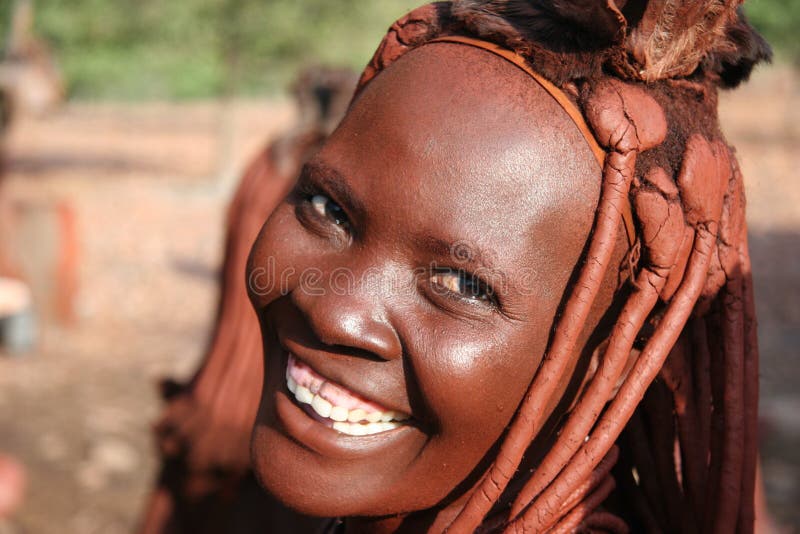 People of Africa, Himba woman looking at camera with smile on her face. Namibia. Africa. People of Africa, Himba woman looking at camera with smile on her face. Namibia. Africa