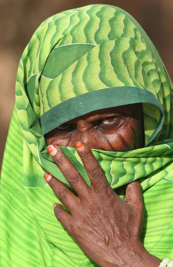 People of Africa. Sudanese old woman hiding behind traditional clothes. Republic of Sudan. People of Africa. Sudanese old woman hiding behind traditional clothes. Republic of Sudan