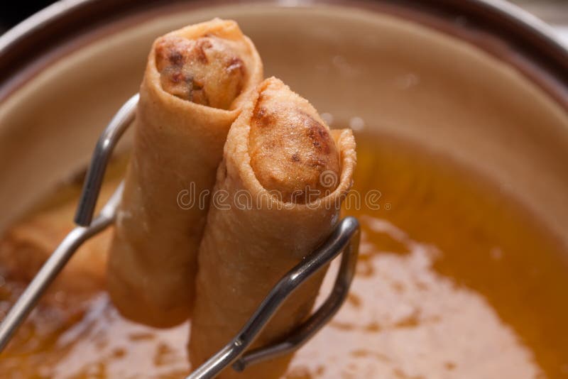 Spring roll with edible oil and pliers. Spring roll with edible oil and pliers