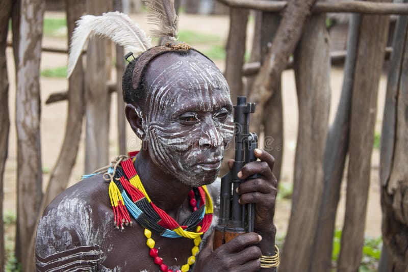 The Karo, or Kara, are a Nilotic ethnic group in Ethiopia famous for their body painting. They are also one of the smallest tribes in the region with an estimated population of 1.000-1.200 people. They are closely related to their neighbors, Hamer and Banna, with a lexical similarity of 81 They live along the east banks of the Omo River in southern Ethiopia and survive on agriculture and natural annual flooding. They have had the same culture and traditions for 500 years, like traditional dancing and painting their bodies with a mix of ash and fat or water.The Karo people differentiate themselves from many of the neighbouring tribes by excelling specifically in body and face painting. They paint themselves daily with coloured ochre, white chalk, yellow mineral rock, charcoal, and pulverized iron ore, all natural resources local to the area. The specific designs drawn on their bodies can change daily and vary in content, ranging from simple stars or lines to animal motifs, such as guinea fowl plumage, or to the most popular – a myriad of handprints covering the torso and legs. Both the Karo and the Hamar men use clay to construct elaborate hairstyles and headdresses for themselves, signifying status, beauty, and bravery.The photo is part of the album `SECOND ETHIOPIAN TRIBES EXPEDITION`. The Karo, or Kara, are a Nilotic ethnic group in Ethiopia famous for their body painting. They are also one of the smallest tribes in the region with an estimated population of 1.000-1.200 people. They are closely related to their neighbors, Hamer and Banna, with a lexical similarity of 81 They live along the east banks of the Omo River in southern Ethiopia and survive on agriculture and natural annual flooding. They have had the same culture and traditions for 500 years, like traditional dancing and painting their bodies with a mix of ash and fat or water.The Karo people differentiate themselves from many of the neighbouring tribes by excelling specifically in body and face painting. They paint themselves daily with coloured ochre, white chalk, yellow mineral rock, charcoal, and pulverized iron ore, all natural resources local to the area. The specific designs drawn on their bodies can change daily and vary in content, ranging from simple stars or lines to animal motifs, such as guinea fowl plumage, or to the most popular – a myriad of handprints covering the torso and legs. Both the Karo and the Hamar men use clay to construct elaborate hairstyles and headdresses for themselves, signifying status, beauty, and bravery.The photo is part of the album `SECOND ETHIOPIAN TRIBES EXPEDITION`