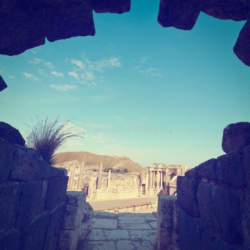 View through the Gap of Ruins of Ancient Bet Shean which Collapsed during Earthquake, Instagram Effect. View through the Gap of Ruins of Ancient Bet Shean which Collapsed during Earthquake, Instagram Effect