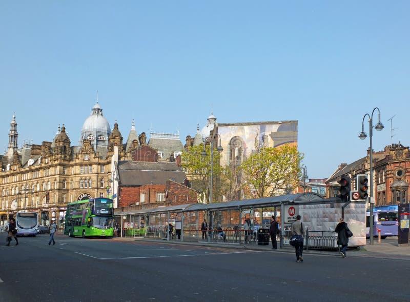 leeds, west yorkshire, england: 17 april 2019: view of new market street with two first buses stopped picking up passengers in leeds city centre. leeds, west yorkshire, england: 17 april 2019: view of new market street with two first buses stopped picking up passengers in leeds city centre