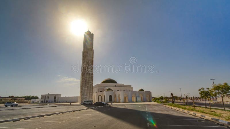 White mosque in Ajman timelapse hyperlapse with sun, United Arab Emirates. White mosque in Ajman timelapse hyperlapse with sun, United Arab Emirates