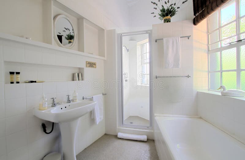 A wide angle photo of a white bathroom. A wide angle photo of a white bathroom