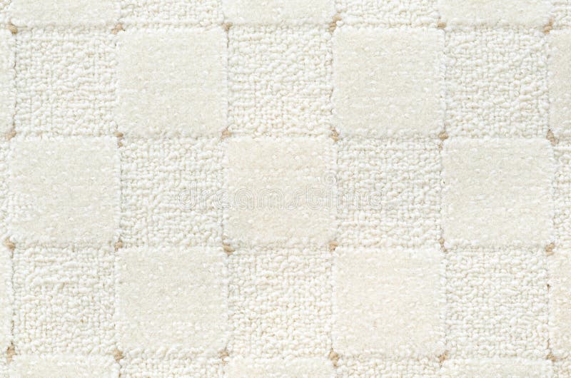 A woolen white carpet with a relief checked pattern. A woolen white carpet with a relief checked pattern