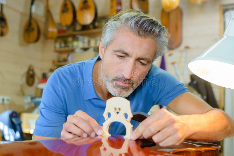 Man making a musical instrument. Man making a musical instrument