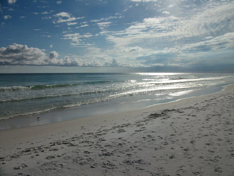 Clouds along the horizon align perfectly with the water and the waves, creating an interesting shot of parallels along the beaches of Destin, Florida. Clouds along the horizon align perfectly with the water and the waves, creating an interesting shot of parallels along the beaches of Destin, Florida.