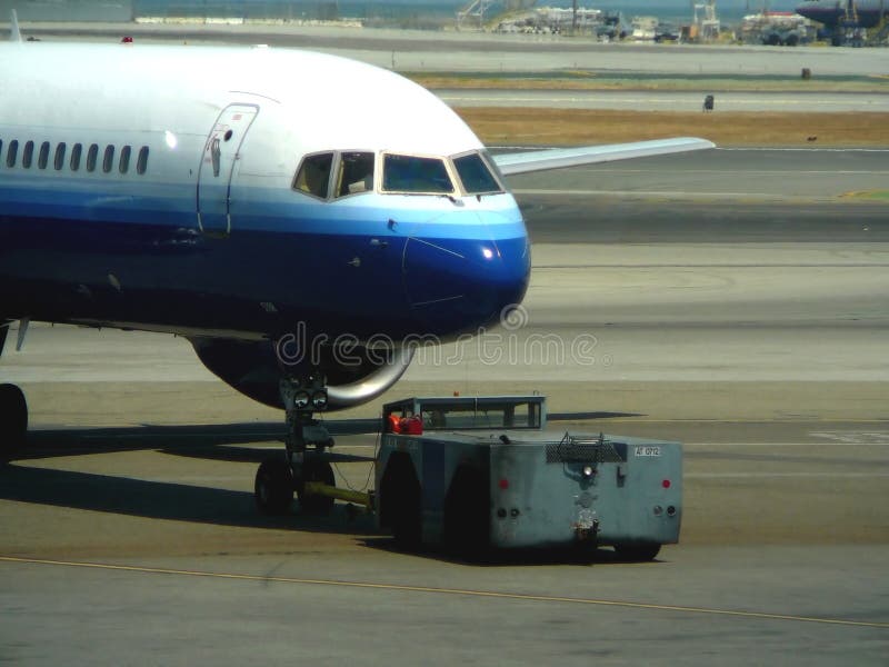 Closeup of pushing aircraft back from airport terminal gate. Closeup of pushing aircraft back from airport terminal gate