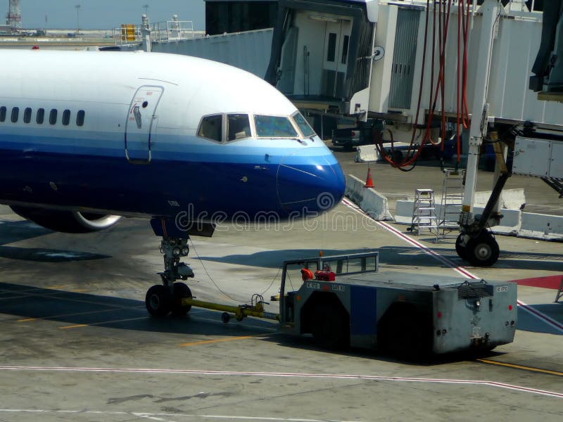 Closeup of pushing aircraft back from airport terminal gate. Closeup of pushing aircraft back from airport terminal gate
