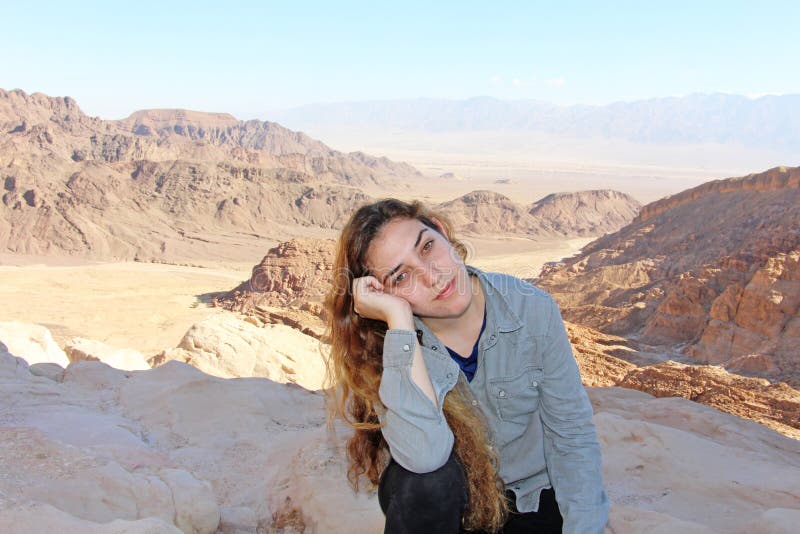 A teenage girl with a tired look on the trip, in the Negev desert, near Eilat, Israel. A teenage girl with a tired look on the trip, in the Negev desert, near Eilat, Israel