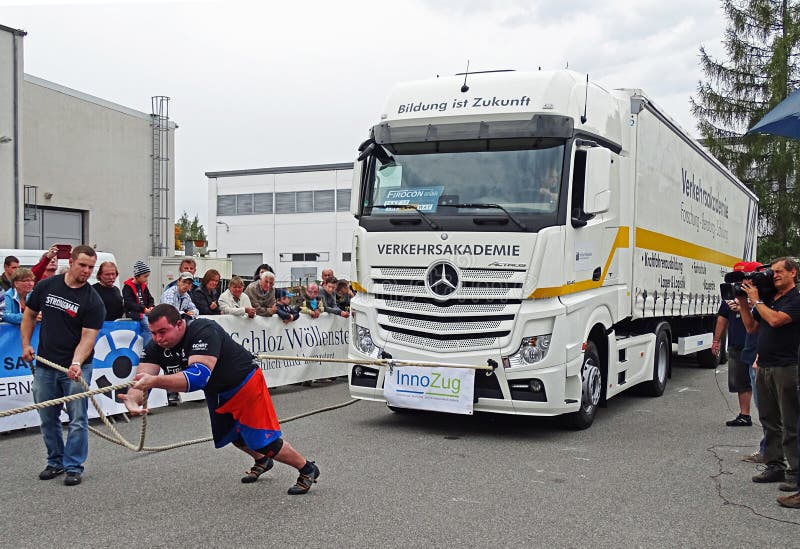 Chemnitz, Germany - October 4, 2015: A strong man pulling a 15 ton heavy truck with a rope in the final of FIROCON Truck Pull European Championships. During the two-day championships, the most powerful men and women in Europe measured their forces. The athletes came from Germany, Poland, the Netherlands, Italy, Switzerland, Austria, Czech Republic, Serbia, Ukraine, Norway and Ireland. Chemnitz, Germany - October 4, 2015: A strong man pulling a 15 ton heavy truck with a rope in the final of FIROCON Truck Pull European Championships. During the two-day championships, the most powerful men and women in Europe measured their forces. The athletes came from Germany, Poland, the Netherlands, Italy, Switzerland, Austria, Czech Republic, Serbia, Ukraine, Norway and Ireland.