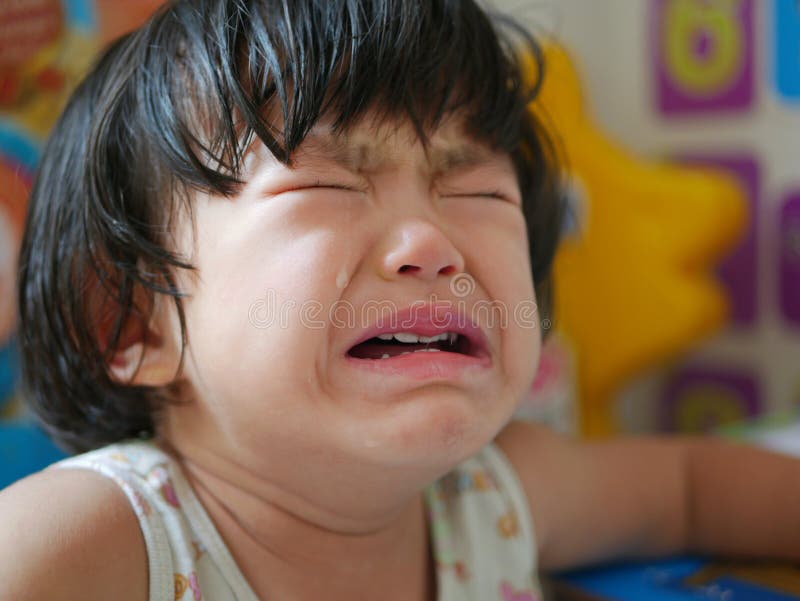 Crying Asian baby girl, two years old, with tears. - selective focus and close up shot. Crying Asian baby girl, two years old, with tears. - selective focus and close up shot