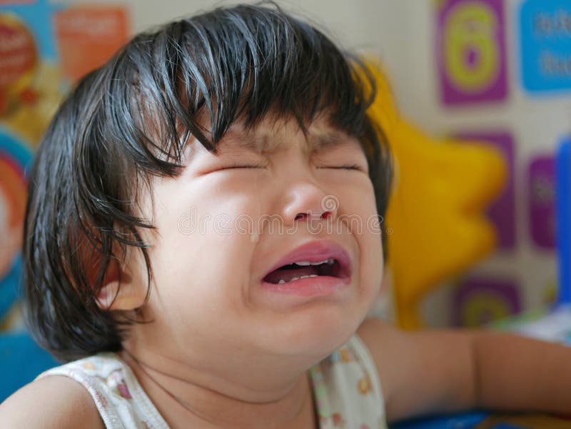 Crying Asian baby girl, two years old, with tears. - selective focus and close up shot. Crying Asian baby girl, two years old, with tears. - selective focus and close up shot