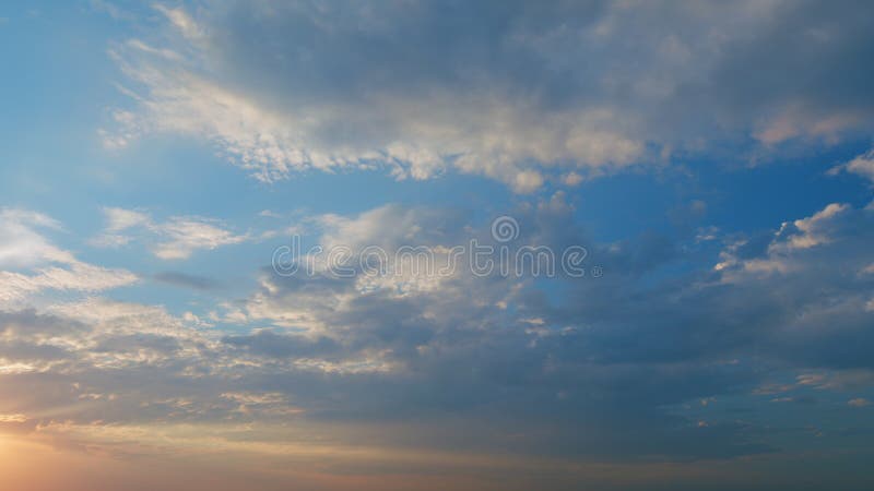 Timelapse. Intense dramatic panoramic sunset. Abstract different shades clouds at sunset sky background. Timelapse. Intense dramatic panoramic sunset. Abstract different shades clouds at sunset sky background.