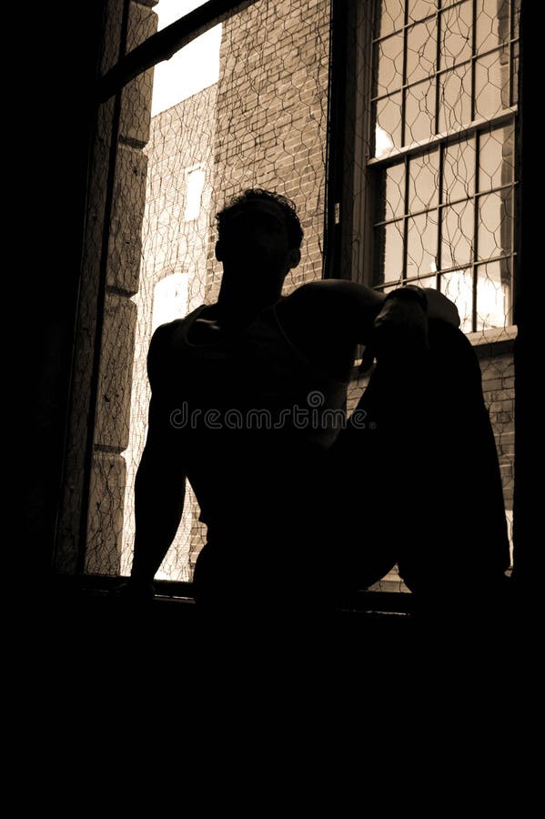 Sillouette of a man in an urban window. Sillouette of a man in an urban window