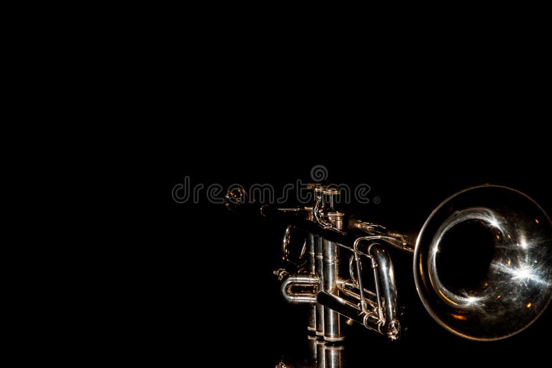 Lonely musical instrument which is a trumpet on a black background. Lonely musical instrument which is a trumpet on a black background