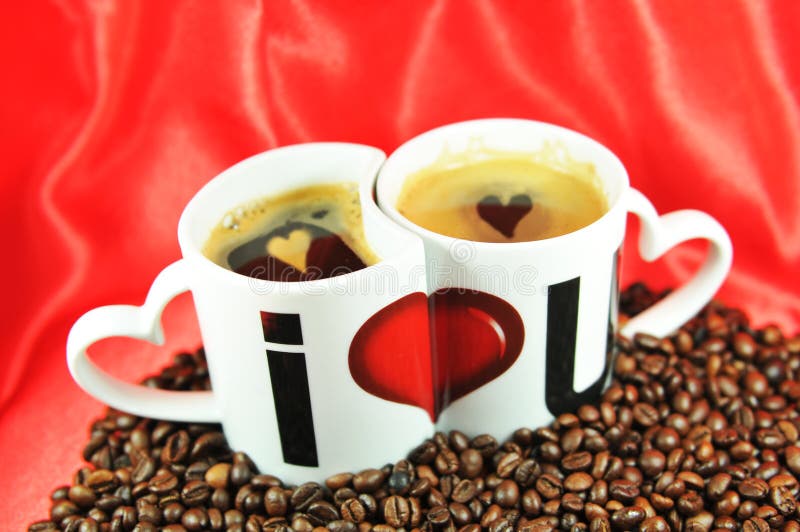 Love coffee concept with twin cups and hearts on red background. Love coffee concept with twin cups and hearts on red background