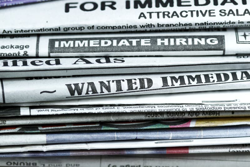Stack of newspaper with Classified ads,immediate hiring,wanted signs. Stack of newspaper with Classified ads,immediate hiring,wanted signs.