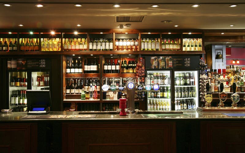 London, UK - June 03, 2011: Inside view of a public house, known as pub, for drinking and socializing, is the focal point of the community, Pub business, now about 53,500 pubs in the UK, has been declining every year. London, UK - June 03, 2011: Inside view of a public house, known as pub, for drinking and socializing, is the focal point of the community, Pub business, now about 53,500 pubs in the UK, has been declining every year.