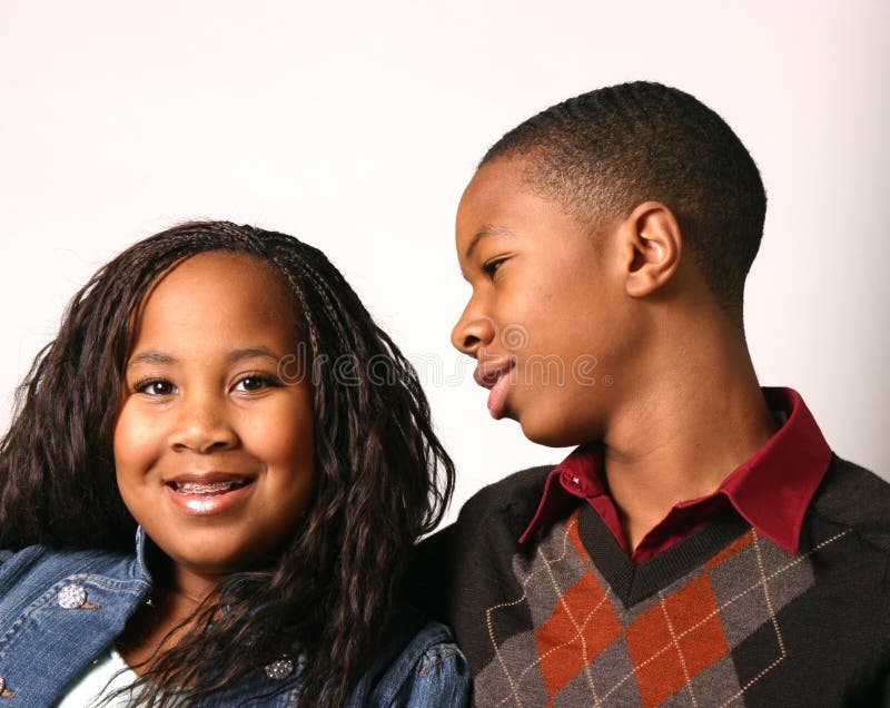 Teenage boy counsels his younger sister with white background. Teenage boy counsels his younger sister with white background