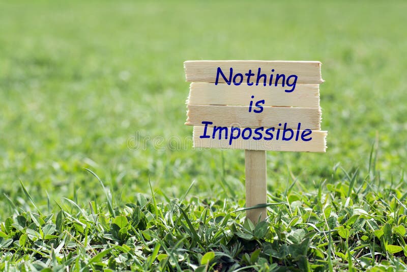 Nothing is impossible wooden sign in grass,blur background. Nothing is impossible wooden sign in grass,blur background
