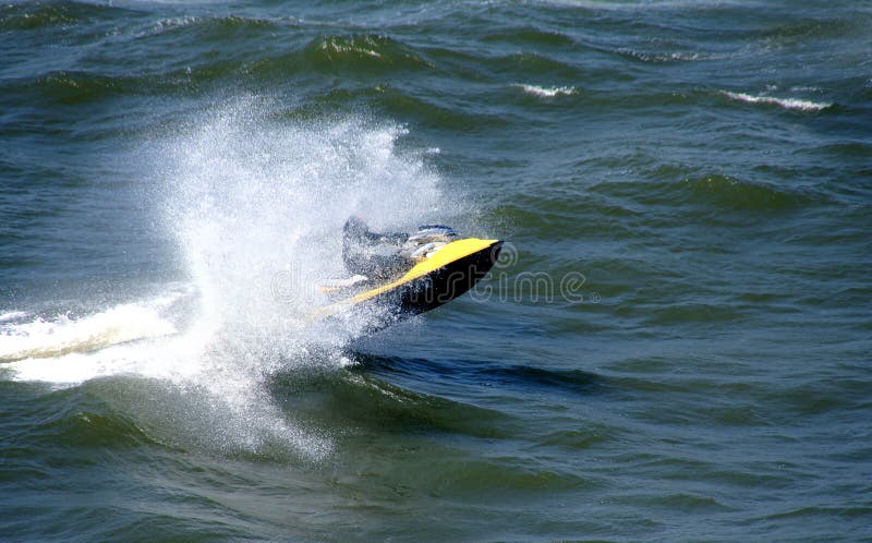 Water sports - Man riding a Jet ski over the sea waves. Water sports - Man riding a Jet ski over the sea waves