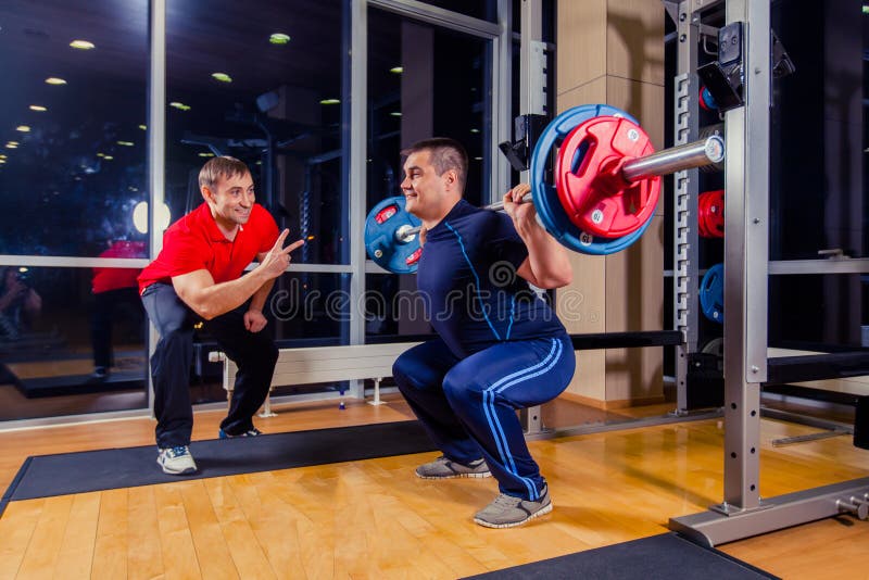 Αθλητισμός, ικανότητα, ομαδική εργασία, bodybuilding έννοια ανθρώπων - άτομο και προσωπικός εκπαιδευτής με τους μυς κάμψης barbel στοκ φωτογραφία με δικαίωμα ελεύθερης χρήσης Αθλητισμός, ικανότητα, ομαδική εργασία, bodybuilding έννοια ανθρώπων - άτομο και προσωπικός εκπαιδευτής με τους μυς κάμψης barbel στοκ φωτογραφία με δικαίωμα ελεύθερης χρήσης