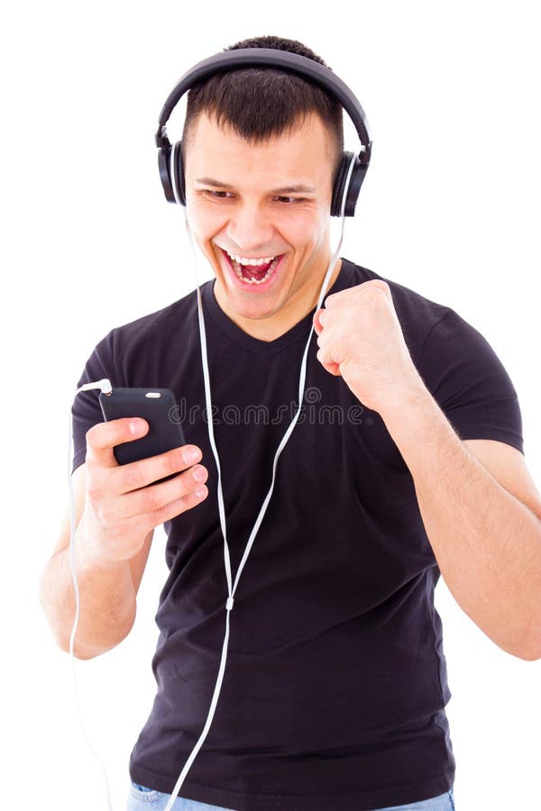 Ακούοντας playlist ατόμων στο κινητό τηλέφωνο που φορά τα ακουστικά στοκ εικόνα Ακούοντας playlist ατόμων στο κινητό τηλέφωνο που φορά τα ακουστικά στοκ εικόνα