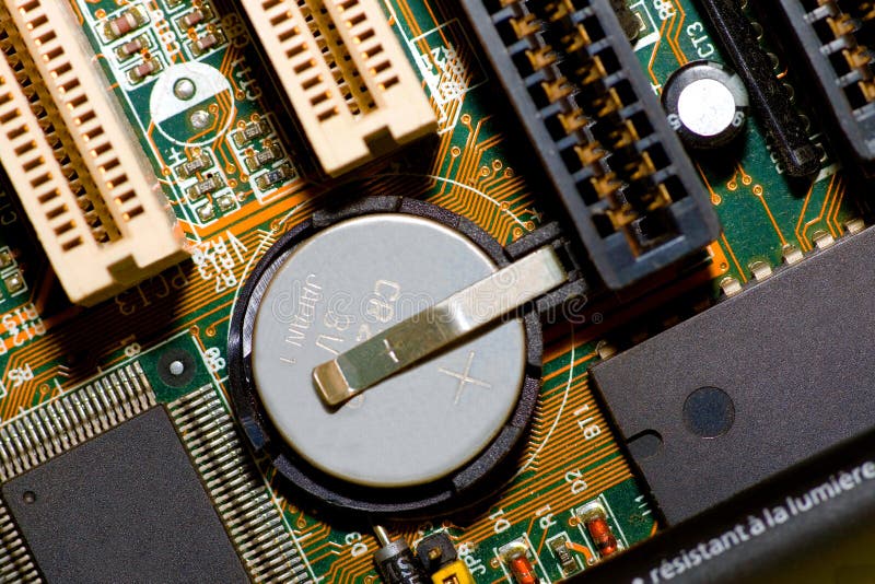 Electronic components extreme macro view from top with battery, microchips, slots, capacitor, resistors and connections. Electronic components extreme macro view from top with battery, microchips, slots, capacitor, resistors and connections