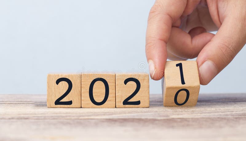 Hand Changing Date From 2020 To 2021 On Wooden Cube Calendar / New Year`s Concept. Hand Changing Date From 2020 To 2021 On Wooden Cube Calendar / New Year`s Concept.