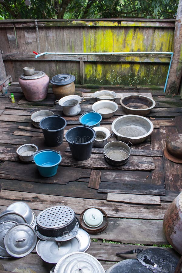 Pots, Buckets, Enameled basin that villager places on the terrace and waiting for measuring the rainfall. Pots, Buckets, Enameled basin that villager places on the terrace and waiting for measuring the rainfall.