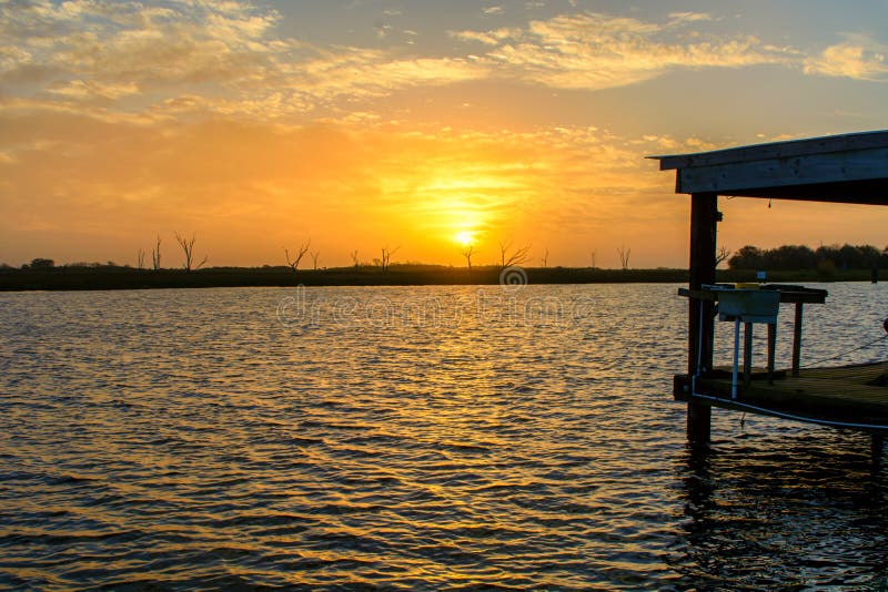 A beautiful sunrise on Bayou Lafourche, Louisiana on the Gulf Coast. A beautiful sunrise on Bayou Lafourche, Louisiana on the Gulf Coast.