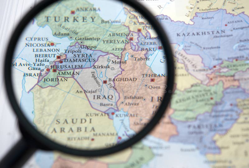 Syria and the Middle East on a map seen through a magnifying glass. Syria and the Middle East on a map seen through a magnifying glass