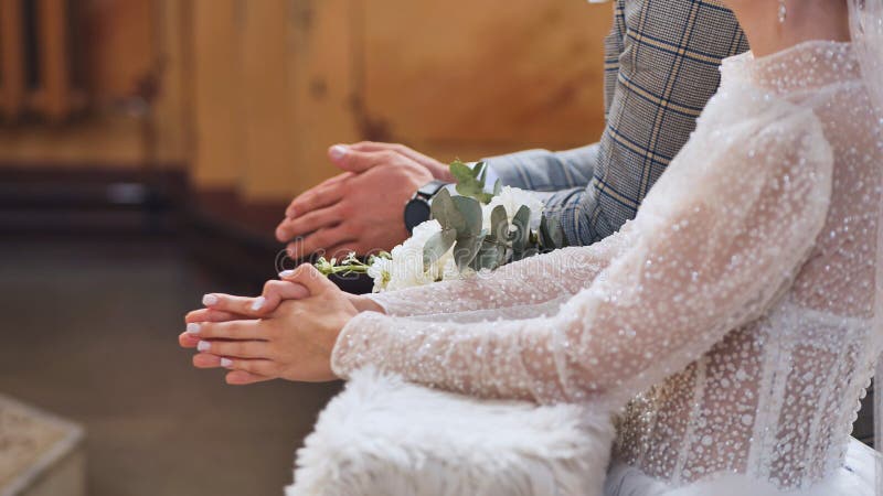 A bouquet of flowers among newlyweds in a Catholic church during a wedding. A bouquet of flowers among newlyweds in a Catholic church during a wedding