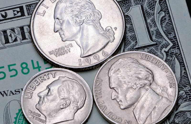 US coins of a quarter dollar, one dime and five cents on a one dollar bill. Reverse of the coin 25, 10, 5 US cents on a banknote 1 US dollar. US coins of a quarter dollar, one dime and five cents on a one dollar bill. Reverse of the coin 25, 10, 5 US cents on a banknote 1 US dollar